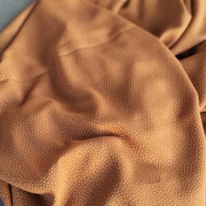 Lichtchocolade bruine stof met nopjes in reliëf